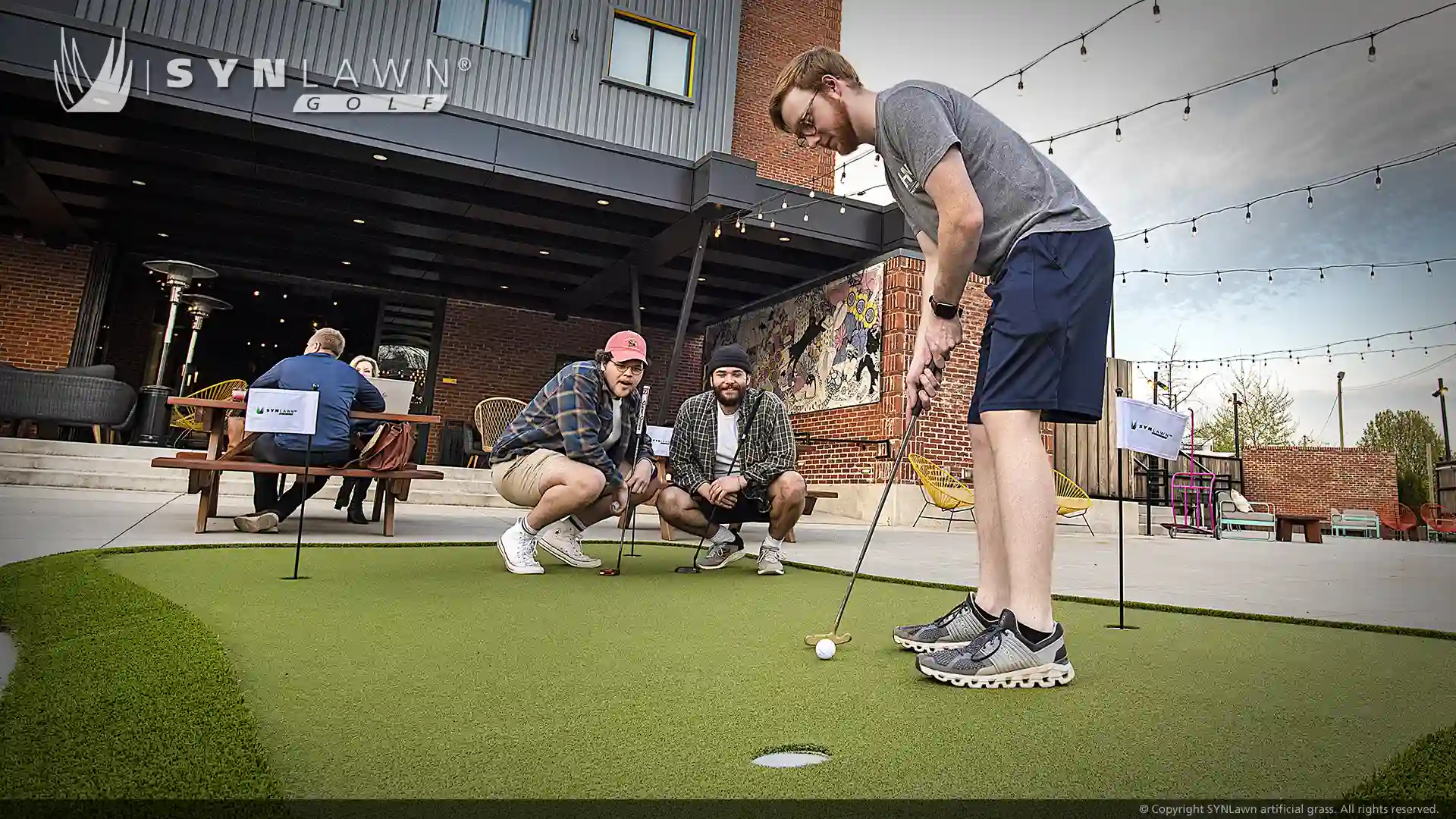 image of golfers playing on the SYNLawn Golf Greenmaker practice putting green