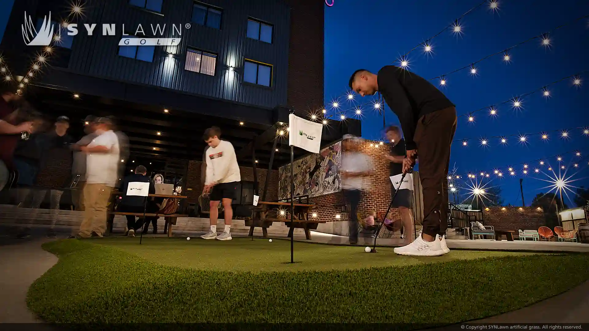 image of golfers playing on the SYNLawn Golf Greenmaker practice putting green